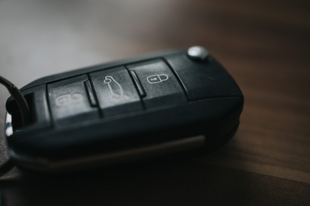 Closeup shot of a black smart car key on a wooden table